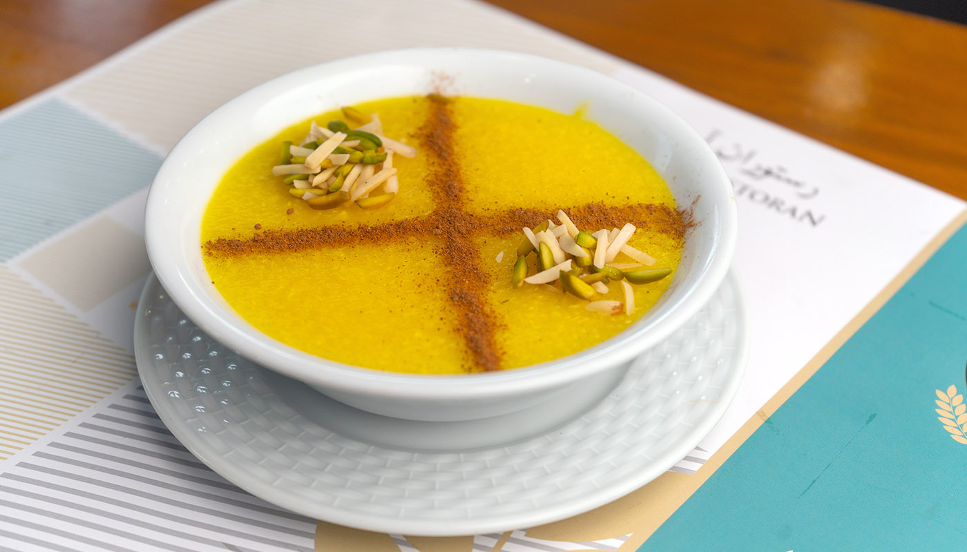 Experience the rich, sweet flavors of Persian Shole Zard, a traditional saffron-infused dessert that's a must-try for any dessert lover.